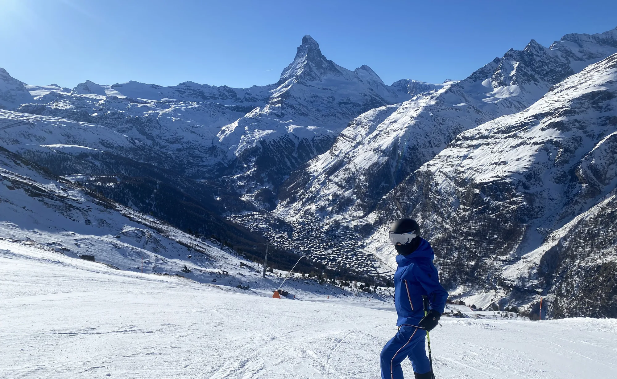 zermatt-town-jasonleftwrightleft — skier above Zermatt village with the Matterhorn, Switzerland